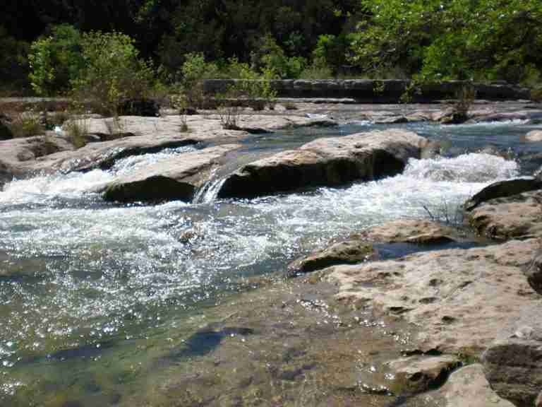 Barton Creek Greenbelt during the rainy season river rapids over the rocks 768x576