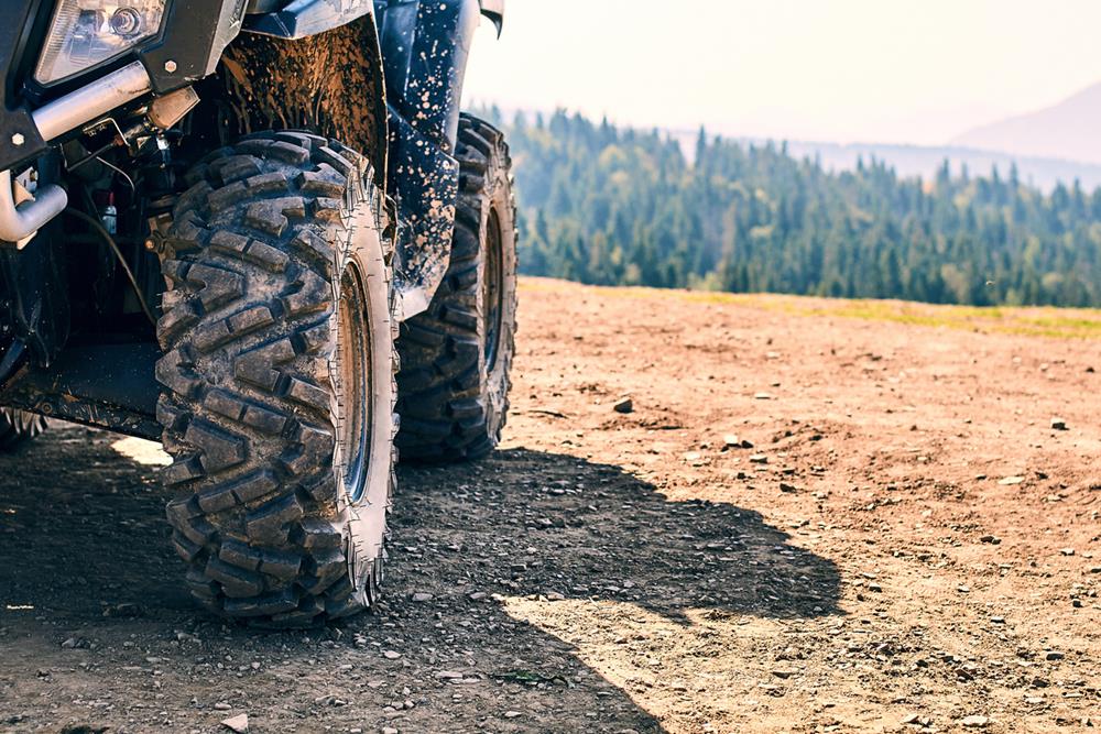 Closeup of ATV tires on an ATV on top of the mountain