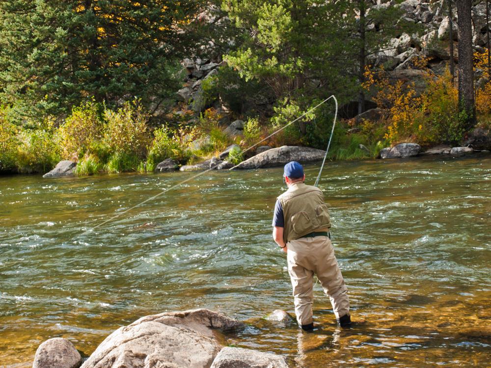 A fly fisherman on a river