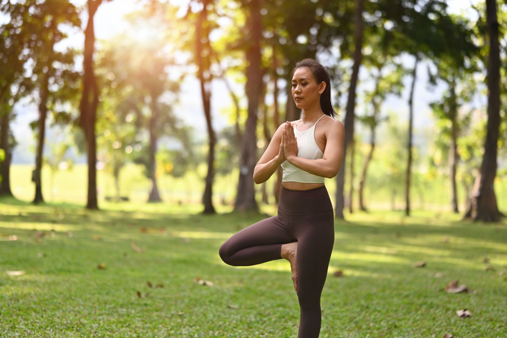 A woman practices Tree Pose