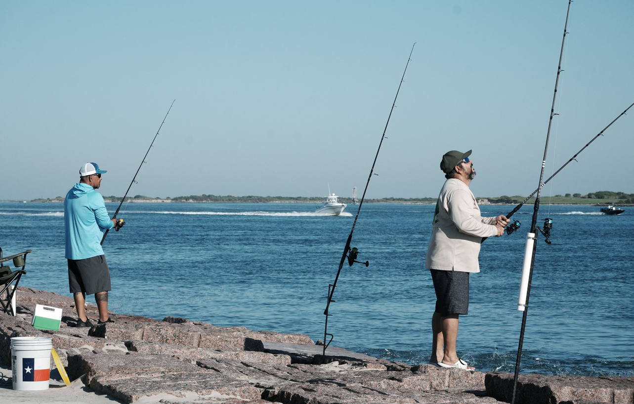 Two men fish off a jetty