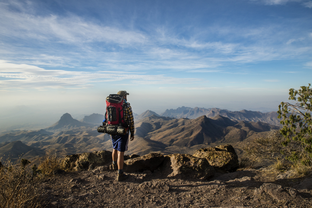 Hiker Stands on a Cliff