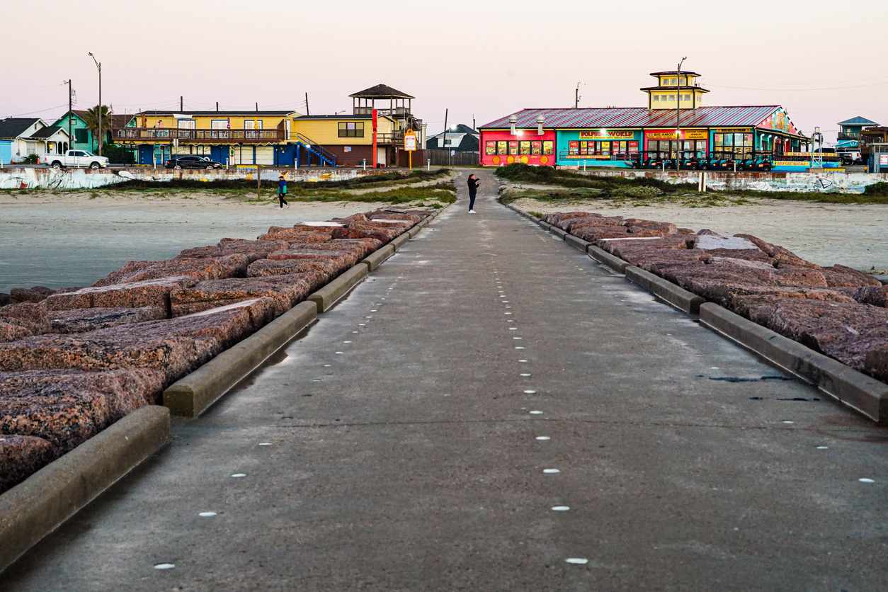 beach, restaurants and seawall on the strand from the jetty in Galveston, Texas