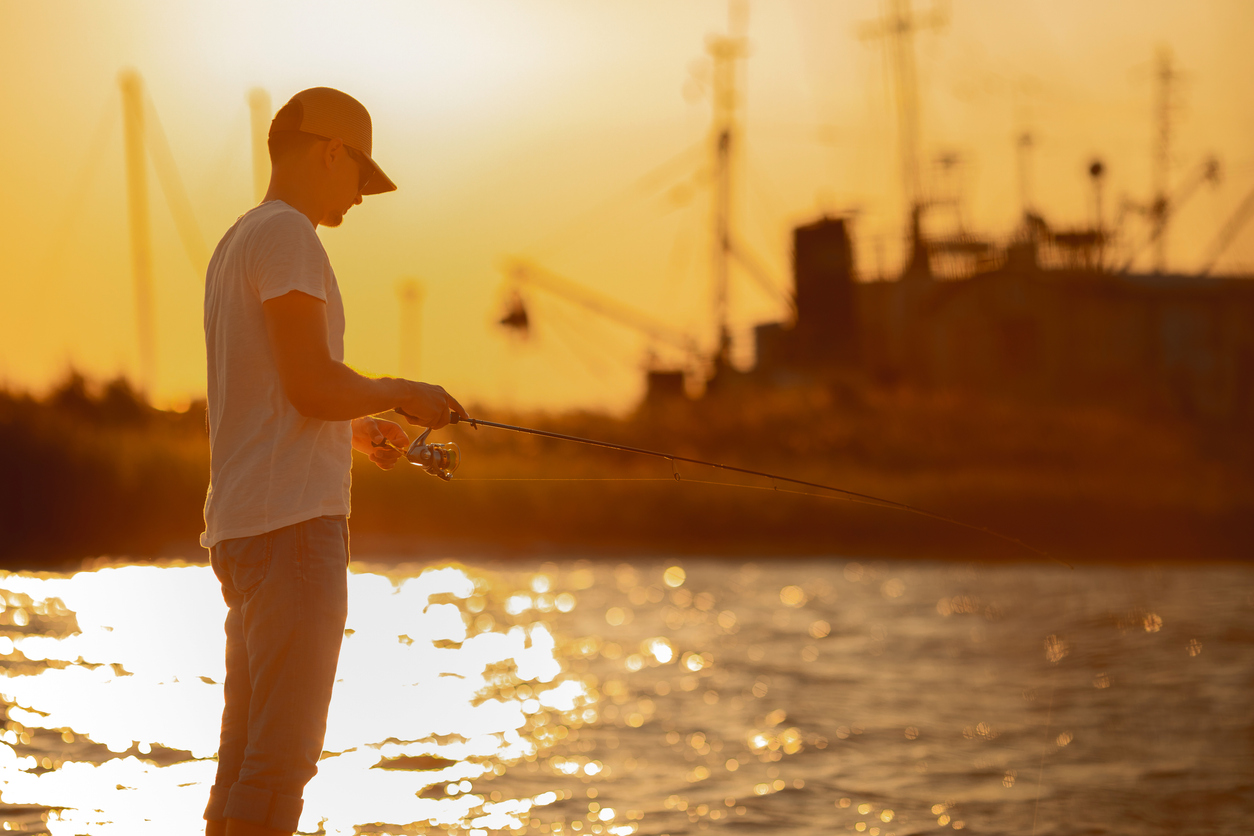 Young man fishing at sea