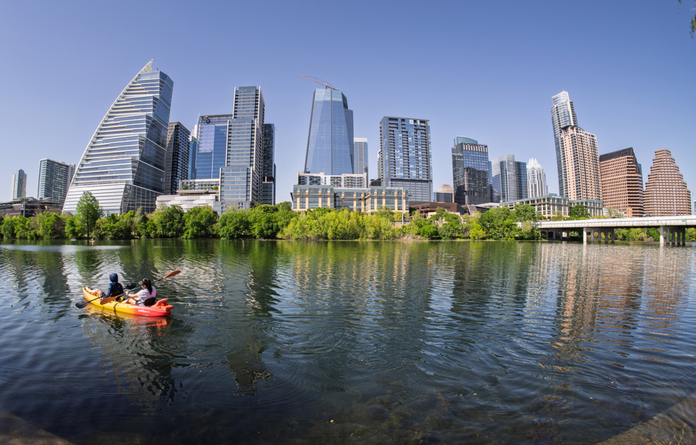 Kayakers paddling from shore on Lady Bird Lake in Austin, Texas