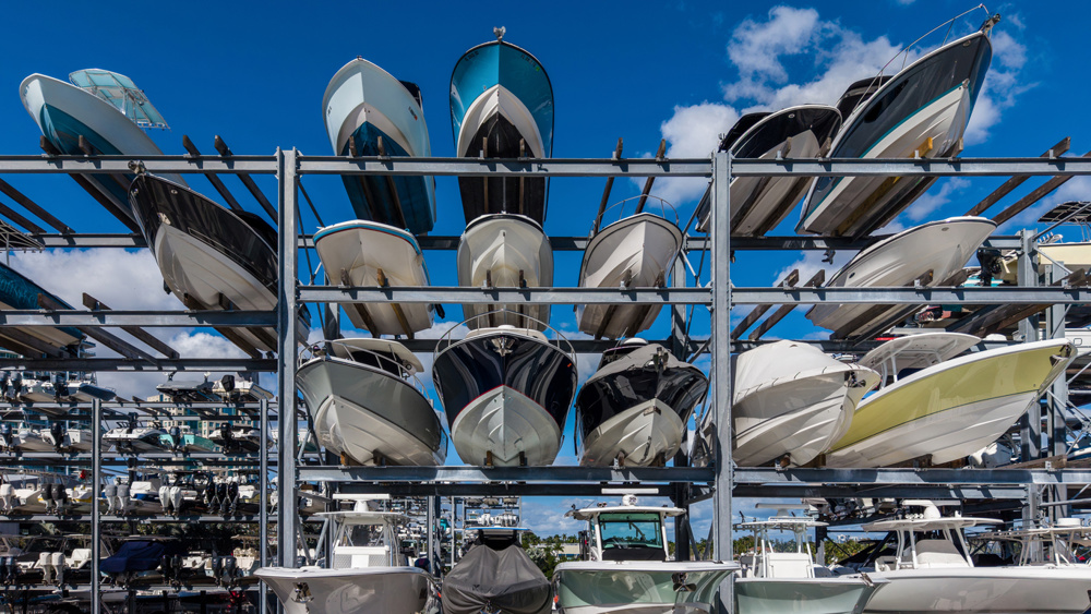 Row of boats sticking out of a boat storage rack in a marina