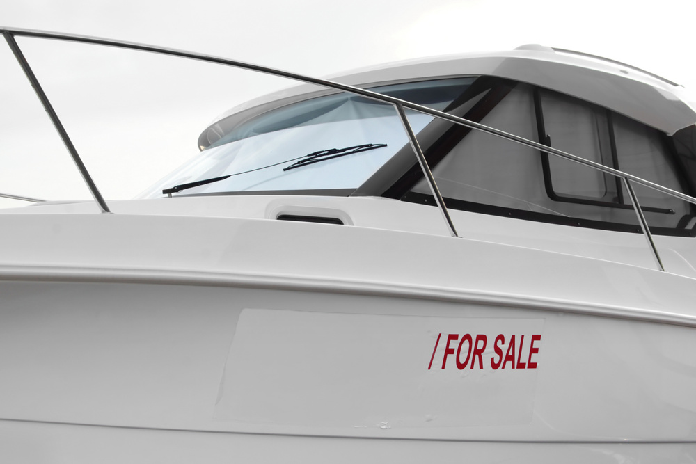 Speedboat with sign SALE on white placard