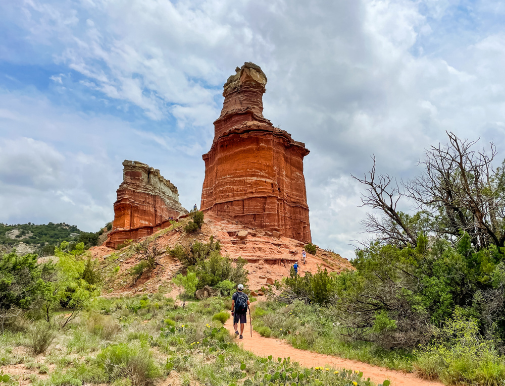 Lighthouse rock with visitors walking towards it in Palo Duro Canyon State Park